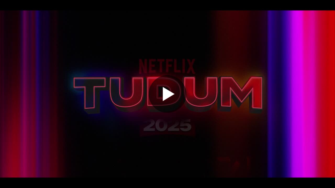 Netflix official social video cover for Tudum 2025 in dark red and magenta light